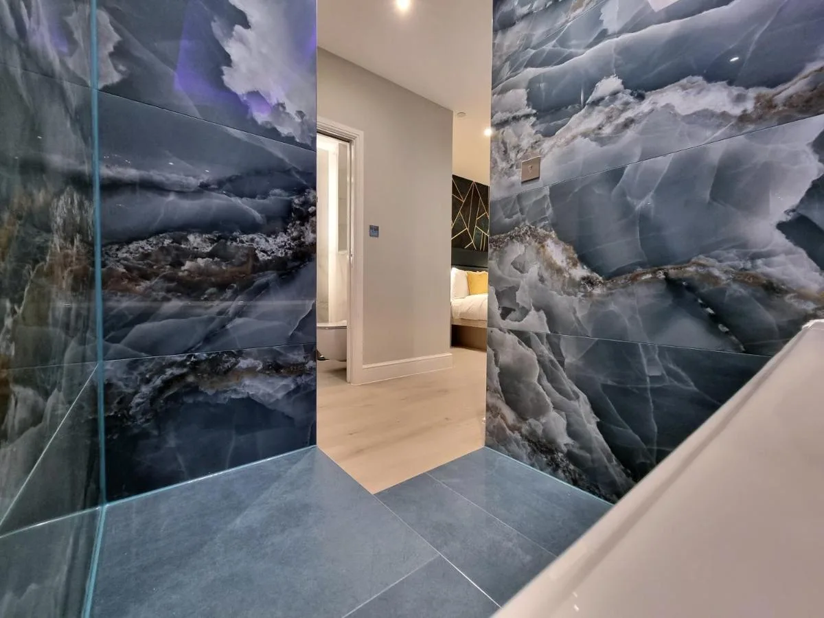 a room with a wall mural of clouds at NOX Kensington Gardens in London