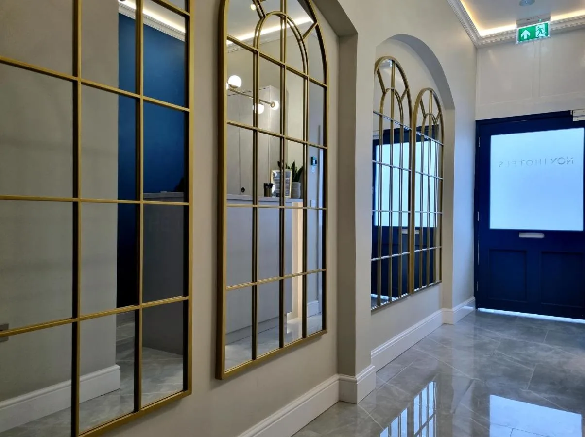 a room with large windows and a projection screen at NOX Kensington Gardens in London